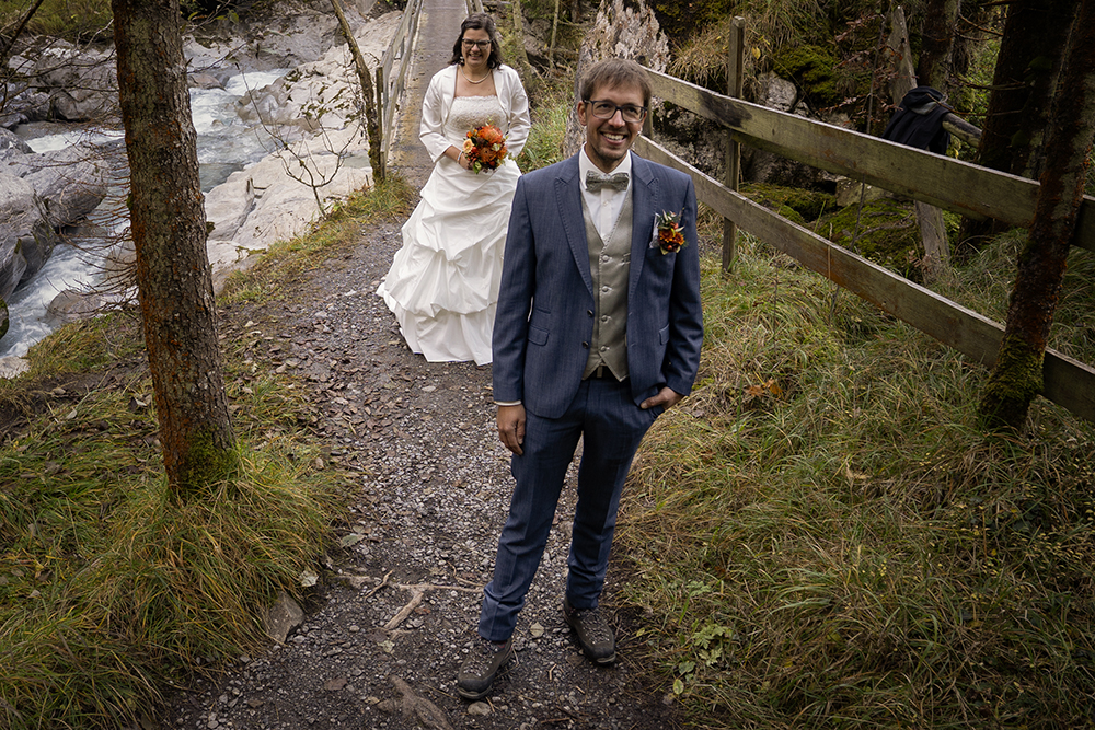 Getting Ready & First Look – Der perfekte Beginn eures Hochzeitstages 1 First Look Hochzeit im Kiental im Berner Oberland – Braut und Bräutigam treffen sich auf Waldweg am Bergbach